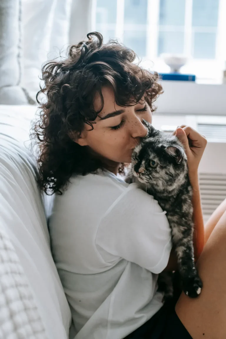Cat cuddling its owner — 7 signs your cat loves you