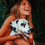 Happy dog with owner — finding the cheapest pet insurance for dogs starts with comparing plan terms