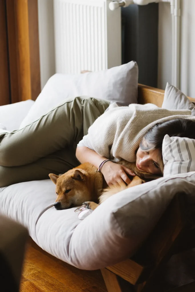How Do Dogs Choose Their Favorite Person? The Science Behind Your Dog's Deepest Loyalties 14 Dog sleeping beside its owner — the ultimate trust sign