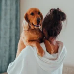 Dog owner deciding if pet insurance is worth it