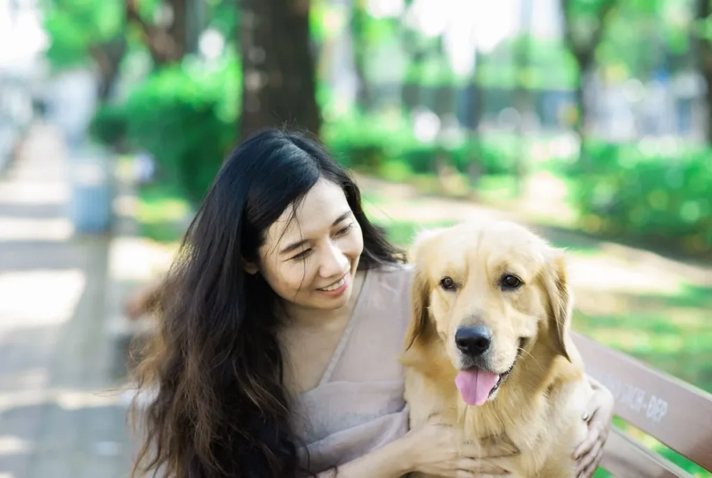 Happy mixed breed dog with its owner — mixed breeds are usually the cheapest dogs to insure