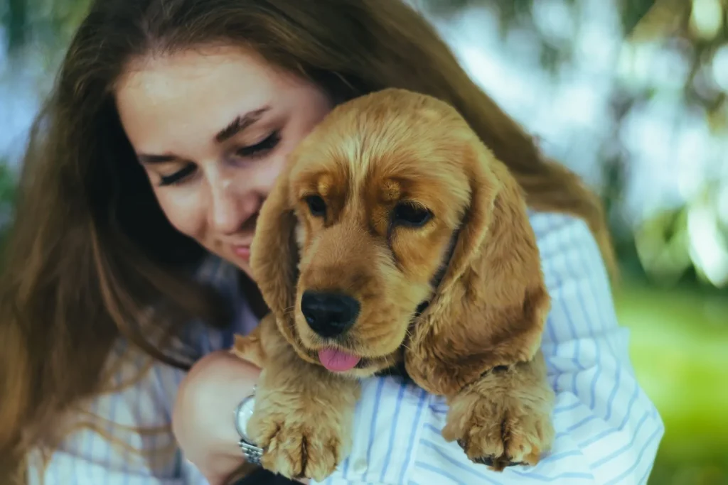 Do You Need Separate Policies for Each Pet? Multi-Pet Rules Explained (2026) 14 Pet owner holding her puppy — choosing the right separate pet insurance policy for each pet