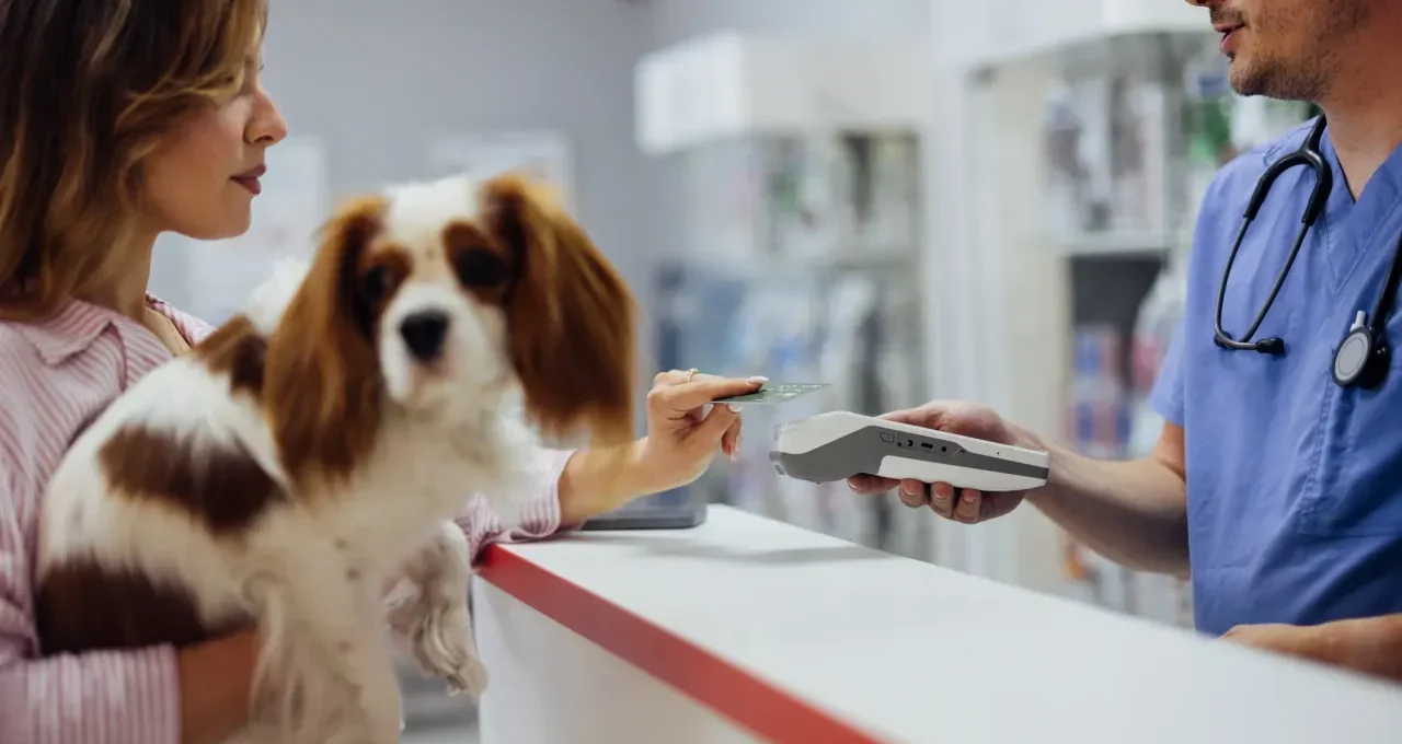 Pet owner reviewing a vet bill with their dog — understanding the pet insurance annual limit