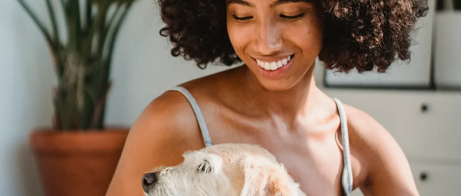 Woman with her dog at home — best dog breeds for single women
